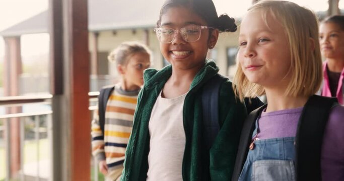 Friends, students and walking at school while talking with backpack for conversation, recess or lunch time. Children, girl and talk with bag, excited and happiness for learning, education and project