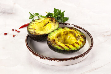 Sliced fresh avocado on the grill