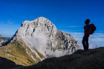 mountaineer woman front Planjava mountain, 2396 meters, julian alps, Slovenia, Central Europe,