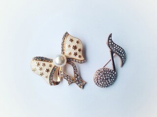 Accessories shaped like butterflies and melodies in yellow and white with imitation gems are...
