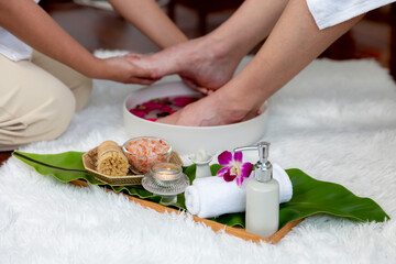 Man indulges in blissful foot massage at luxurious spa salon while masseur give reflexology therapy...