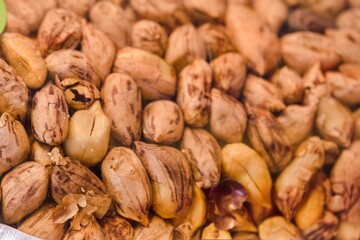 A close up of nuts with some of them being cracked open