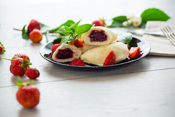 cooked sweet homemade steamed dumplings with strawberries