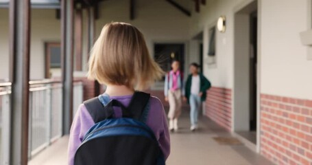 Young girl, student and walking with backpack for education or learning journey in school building. Back of child, kid or elementary learner with bag to classroom for knowledge or future on campus - Powered by Adobe