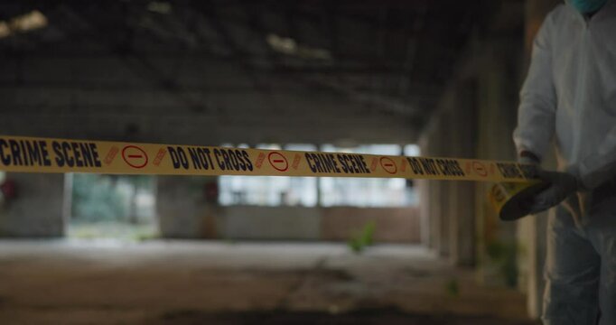 Crime, scene and ribbon with police tape for barricade, crossing block or investigation with closure or no entry. Investigator person closing area, evidence and mystery, sign for keep out or warning