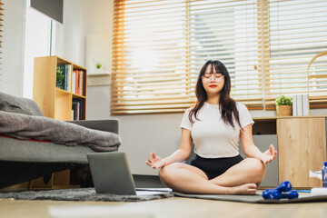 Woman meditating alone after exercising