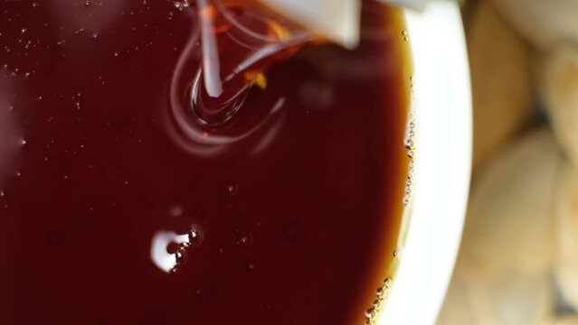 Macro process of pouring vegetable brown oil, slow motion.