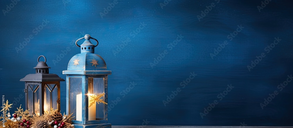 Poster a festive christmas lantern adorned on a blue wooden backdrop in a studio setting with copy space im