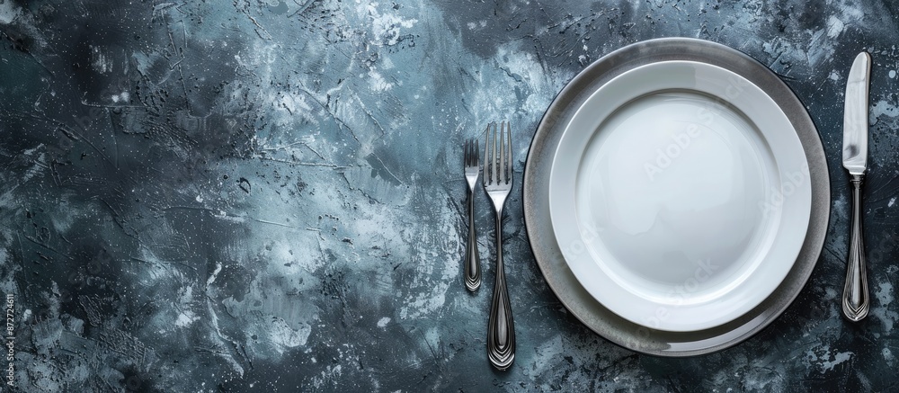 Poster gray stone concrete table with an empty white ceramic plate, knife, and fork. perfect for menu or re