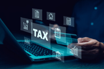 Hand using a laptop with TAX REFUND and refund tax of duty taxation business, graphs and chart being demonstrated on the screen media,  tablet pc and selecting tax refund, Saving tax for business