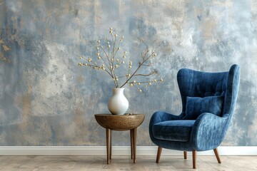 Delight in the minimalist beauty of a modern living room featuring a blue wingback chair and side table adorned with a vase and branch, against a Venetian stucco wall.