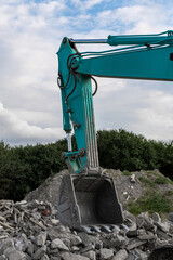 Obraz premium Close up of teal excavator boom on the construction site