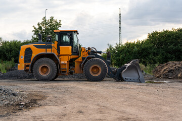Yellow front loader on the construction site