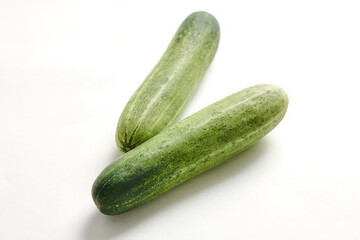 Two cucumbers on an isolated white background