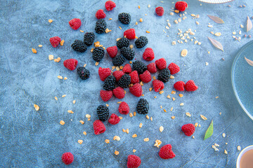 Colorful berry pattern of various fresh ripe wild berries on light blue background