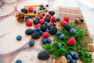 Mix of blackberry blueberry raspberry black currant in wicker baskets