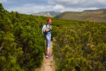 Woman hiking in the mountains with backpack