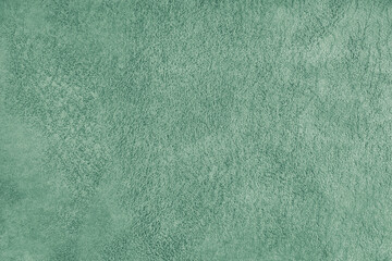 Naklejka premium Green suede leather texture with embossed pattern background, fleecy cloth texutre macro