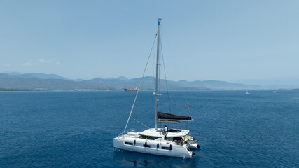 Aerial drone photo of beautiful catamaran sailing yacht anchored in tropical exotic turquoise sea...