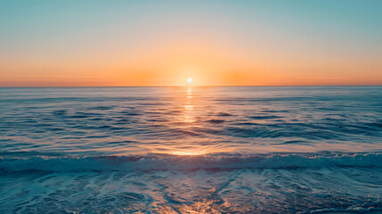 Obraz premium The ocean is calm and the sun is setting, creating a beautiful