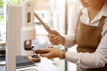 Barista making a cup of coffee at the coffee shop