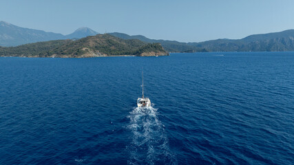 Aerial drone photo of beautiful catamaran sailing yacht anchored in tropical exotic turquoise sea...