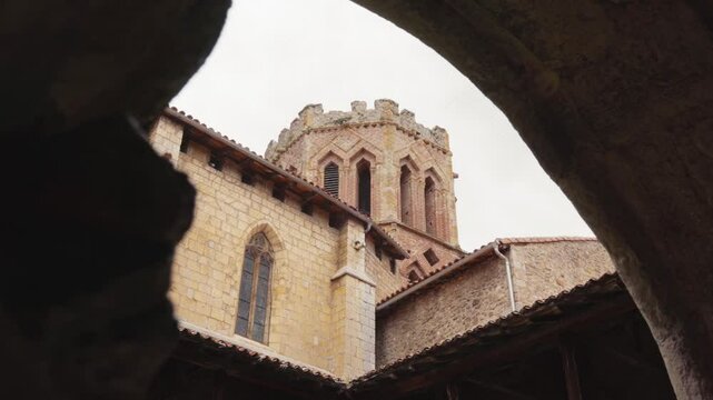 Cinematic shot of tower bell of Saint Lizier Cathedral from inside in France. Low angle view.