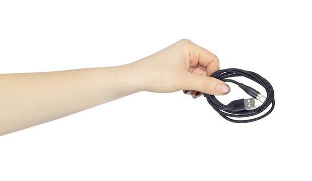 USB - Type-C cable in hand, outstretched hand with USB - Type-C cable, isolated from background