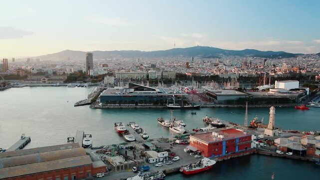Aerial view of Barcelona's Port Vell. In the foreground the Moll de Pescadors with the Rellotge Tower and moored boats.