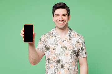 Young Caucasian man he wears white shirt casual clothes hold in hand use mobile cell phone with blank screen workspace area isolated on plain pastel light green background studio. Lifestyle concept.