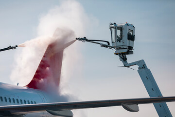 Deicing of airplane before flight. Winter frosty day at airport..