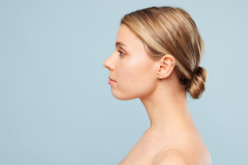 Side profile view attractive Caucasian beautiful half naked topless young woman 20s with nude make...