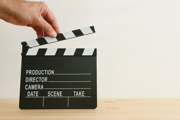 Obraz premium movie clapper on wooden table. Concept of entertainment production