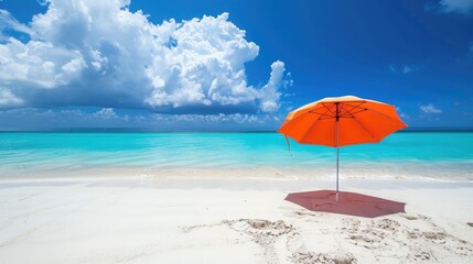 Sandy beach with white sand blue sky and umbrella