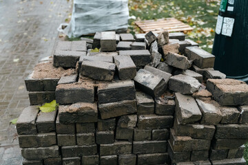 Disrepair and Renovation: Stacked Weathered Paving Slabs in Street Revamp