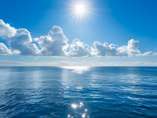 Obraz premium Sunlit Ocean With Blue Sky and Clouds