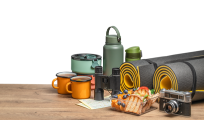 healthy snack of tourists with different camping equipment on a wooden board. food for the trip isolated on white