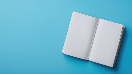 Top view of open notebook on blue background for customization Represents business office or education