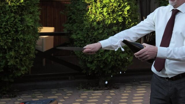 opening a bottle of champagne with a knife. Cork coming out of a bottle of champagne