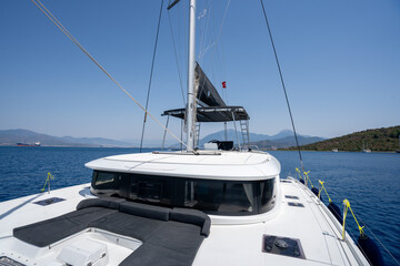 Deck of catamaran with  floating in blue sea water on sunny day
