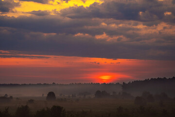 summer evening, sunset in yellow, orange and pink with clouds, background