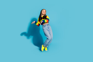 Obraz premium Full length photo of lovely young lady enjoy disco dancing tiptoes dressed stylish striped garment isolated on blue color background