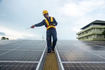 A solar panel installation company employee assembles a photovoltaic system on the roof.