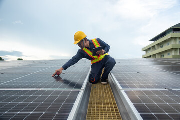 A solar panel installation company employee assembles a photovoltaic system on the roof.