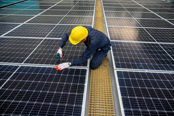 Workers installing solar panels are building a photovoltaic system on the roof.