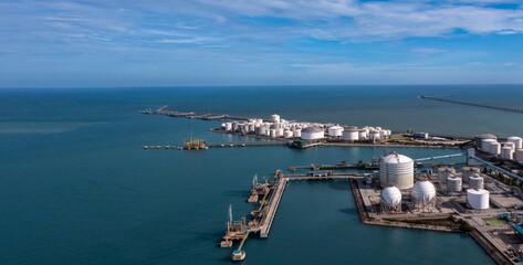 Fototapeta premium Aerial view oil and gas depot industrial facility for storage petrochemical product, Crude oil and gas depot terminal storage tank petroleum petrochemical refinery product.