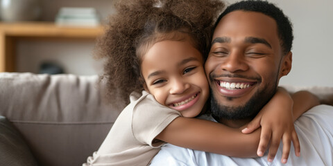Fototapeta premium A father and daughter embracing warmly on a sofa at home, enjoying precious moments of love and bonding.
