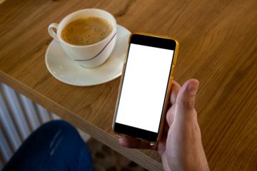 Hand holding blank screen smartphone at the cafe, mockup phone, transparent background png