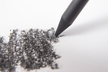 Charcoal or graphite sharp pen crayon strokes on white paper, soft focus close up