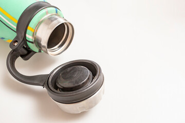 Plastic cap of a  Thermos flask isolated on white background, soft focus close up